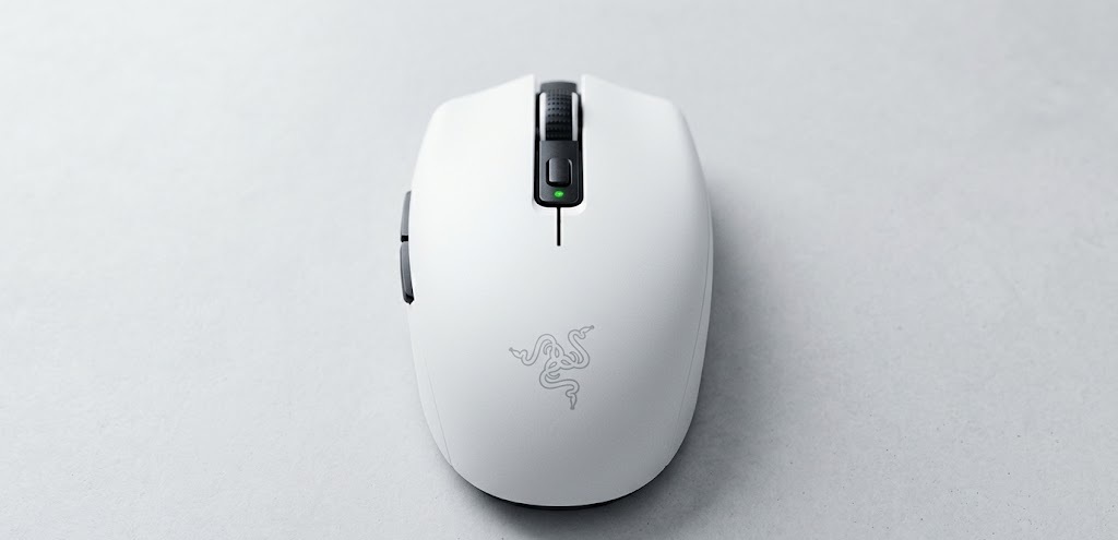 White Razer Orochi V2 mobile wireless gaming mouse for small hands on a black mousepad.