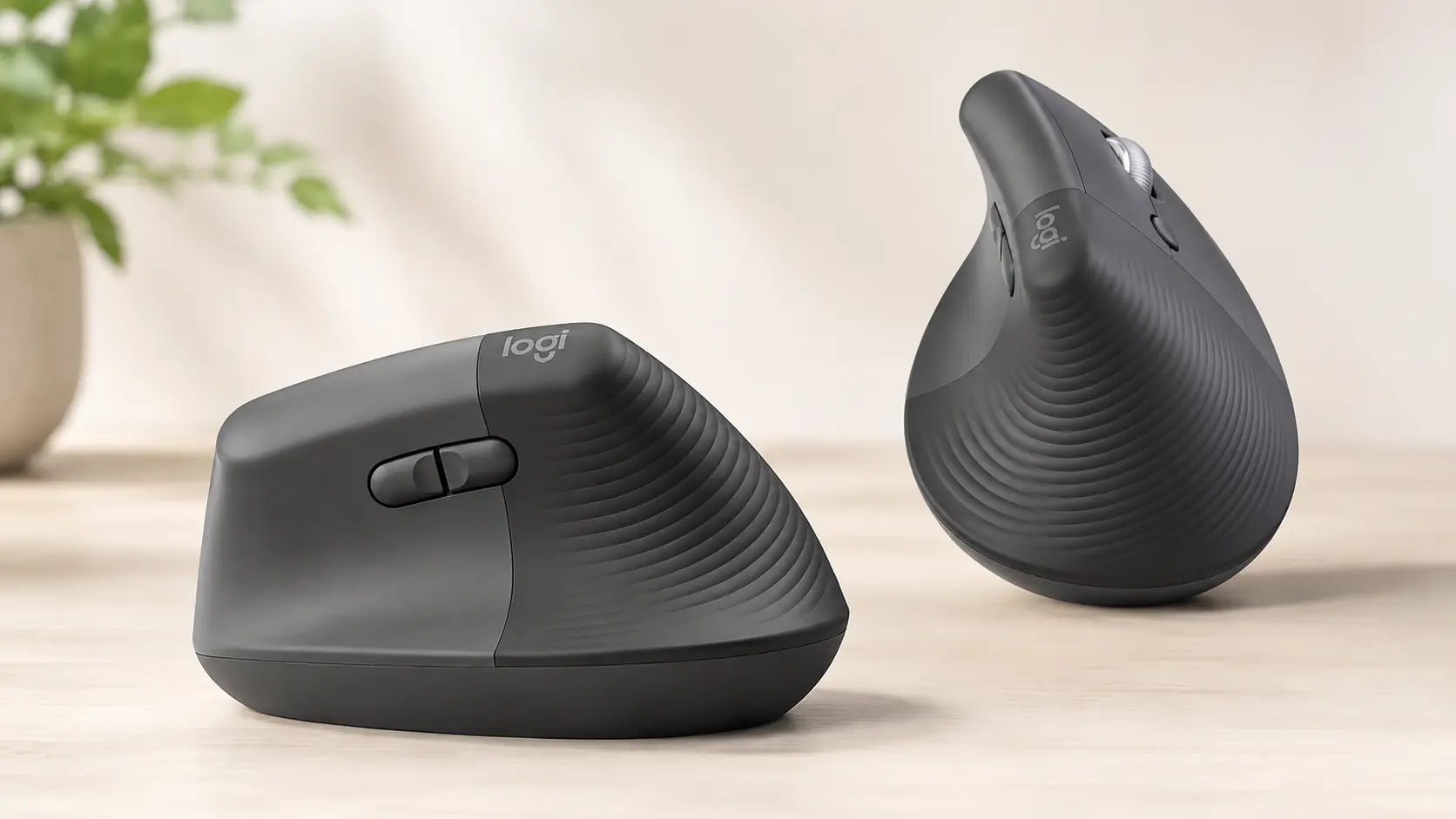 Two Graphite Logitech Lift vertical ergonomic wireless mice demonstrating the textured back grip and scientifically proven 57-degree angle.